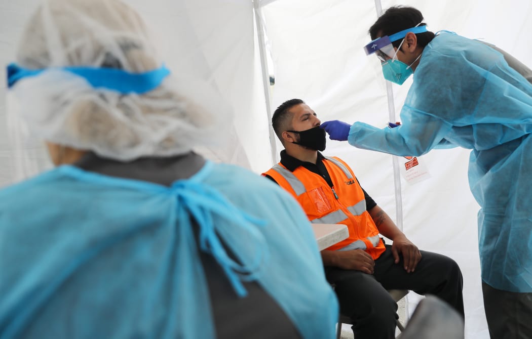 Jose Deloera is tested for COVID-19 at a testing site provided by the International Brotherhood of Teamsters on July 16, 2020 in Long Beach, California.