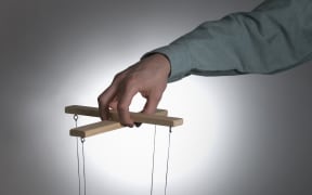 Male operating puppet controls (Photo by Chris Whitehead / Cultura Creative / Cultura Creative via AFP)