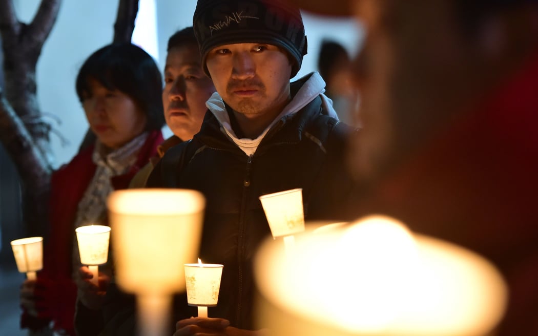 South Koreans hold a vigil to wish for Mark Lippert's quick recovery.