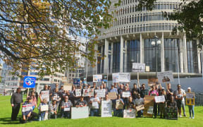 Migrant family protest outside Parliament.