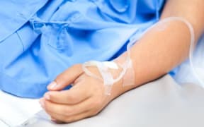 Person in hospital bed.