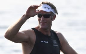 New Zealand's Mahe Drysdale waves after winning the Men's Single Sculls Quarterfinal rowing competition at the Lagoa stadium during the Rio 2016 Olympic Games in Rio de Janeiro on August 9, 2016.