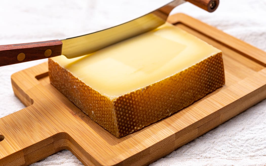 Block of Swiss medium-hard matured cheese gruyere used for baking, quiche, fondue, sandwiches  close up
