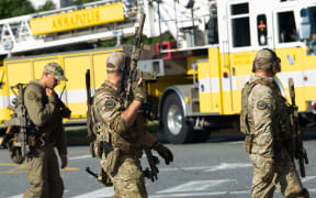 Police respond to a shooting in Annapolis, Maryland, where at least five people were killed when a gunman opened fire inside the offices of the Capital Gazette.
