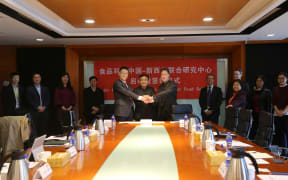 A joint handshake to mark the signing of the agreement between Jolon Dyer (from right), Professor Shuntang Guo and Dr Xinghe Niu.