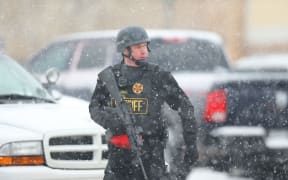 A member of the Colorado Springs sheriff's department secures the scene during an active shooter situation near a Planned Parenthood facility where an unidentified suspect has reportedly injured up to nine people, including at least four police officers, on November 27.