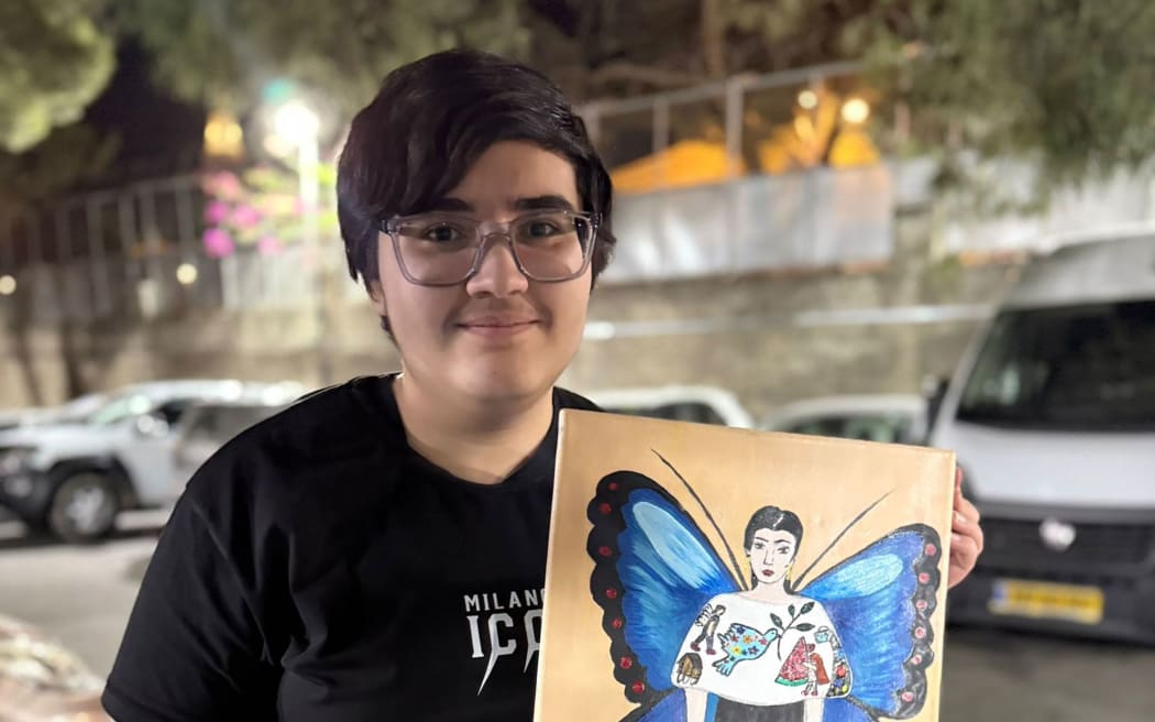 Yamen painted popular children's entertainer Ms. Rachel wearing a dress embroidered with paintings from children in Gaza.
Mandatory Credit:	Courtesy Al-Najjar family via CNN Newsource