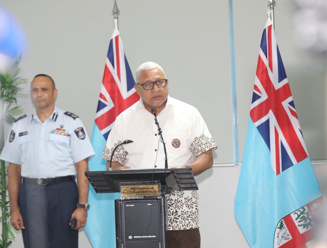 Fiji's PM, Frank Bainmarama gives the a Covid-19 update, with Police Commissioner Sitiveni Qiliho behind him