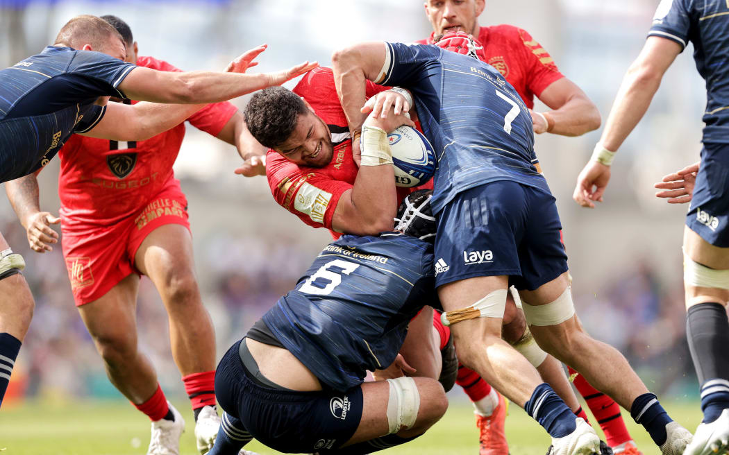 Toulouse's Emmanuel Meafou is tackled by Caelan Doris and Josh van der Flier of Leinster.