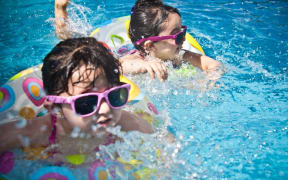 Children learning to swim.