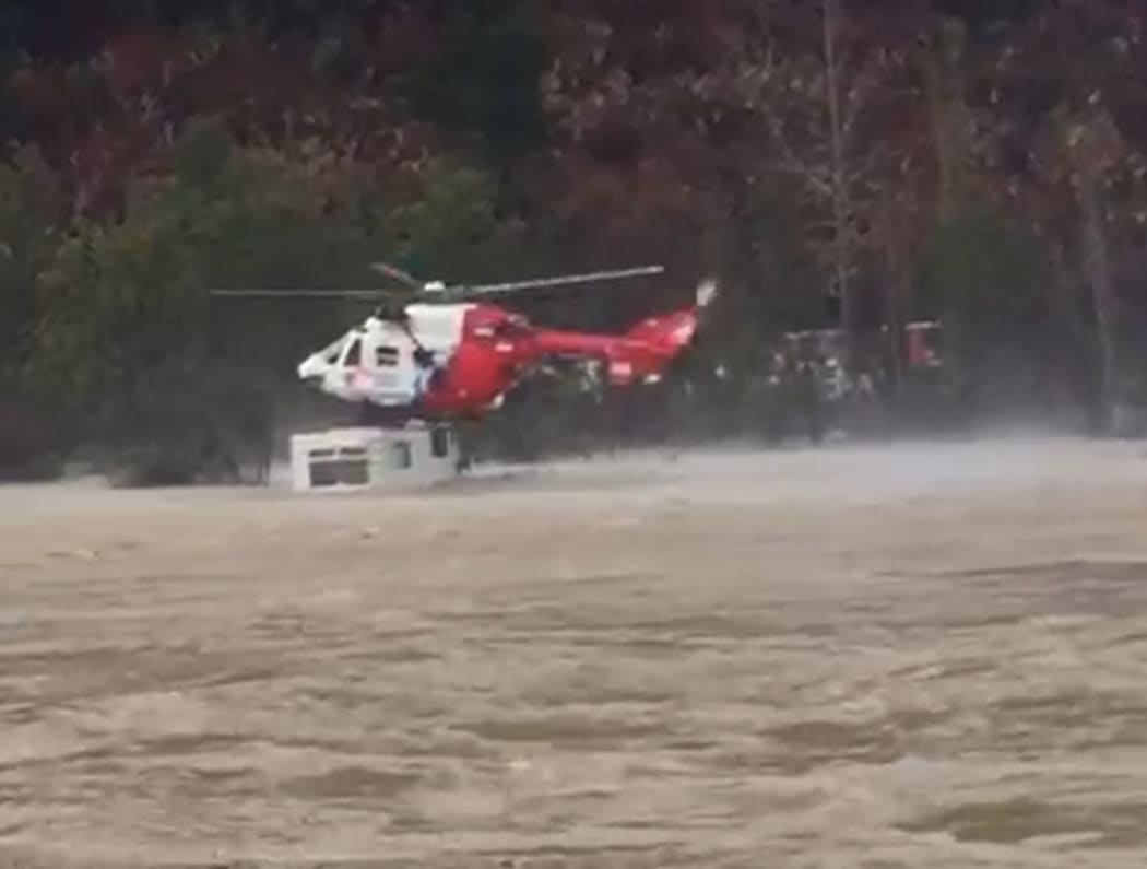 Nelson Marlborough Rescue Helicopter rescues a man after his car was submerged and his caravan partially submerged by the rising Motueka River