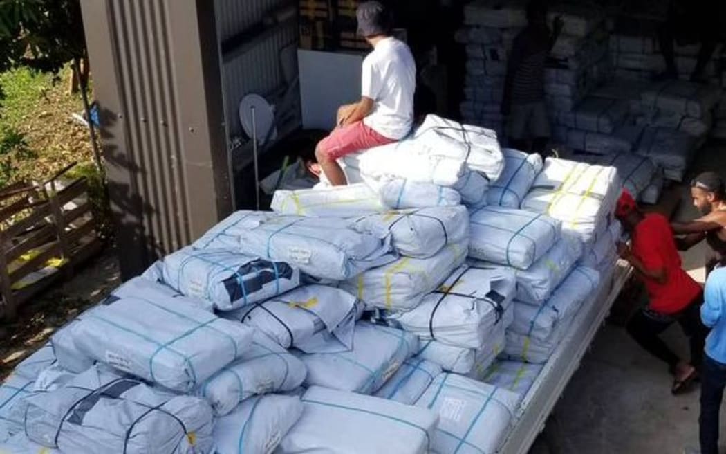 A red cross truck is filled with family packs for people on Ambae
