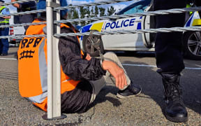 Police moved passenger rail protesters from the Transmission Gully motorway and handcuffed them to a barrier to allow traffic to use the road.