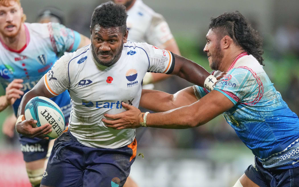 Moana Pasifika's Timoci Tavatavanawai is tackled by a Rebels player.