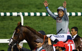 California Chrome and jokey Victor Espinoza after winning the Dubai World Cup.