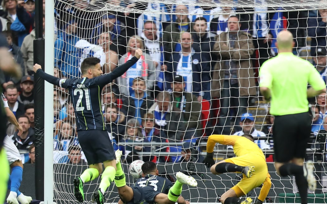 Gabriel Jesus of Manchester City scores from a diving header