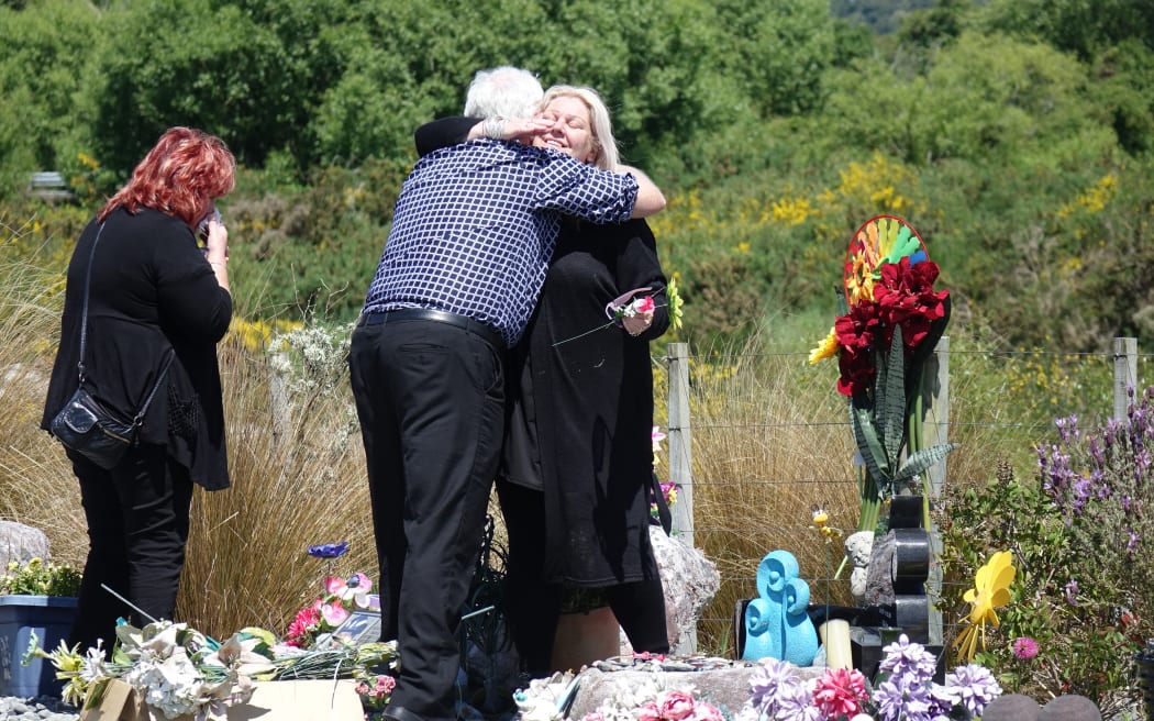 Sonya Rockhouse receives a hug from Bernie Monk at Atarau, a memorial site near the Pike River Mine. Both lost sons when the mine exploded in 2010.