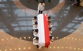 The coffin carrying Lee Kuan Yew's body is transferred from Parliament House for his funeral procession.