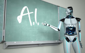 Humanoid robot in the classroom with a green chalkboard.