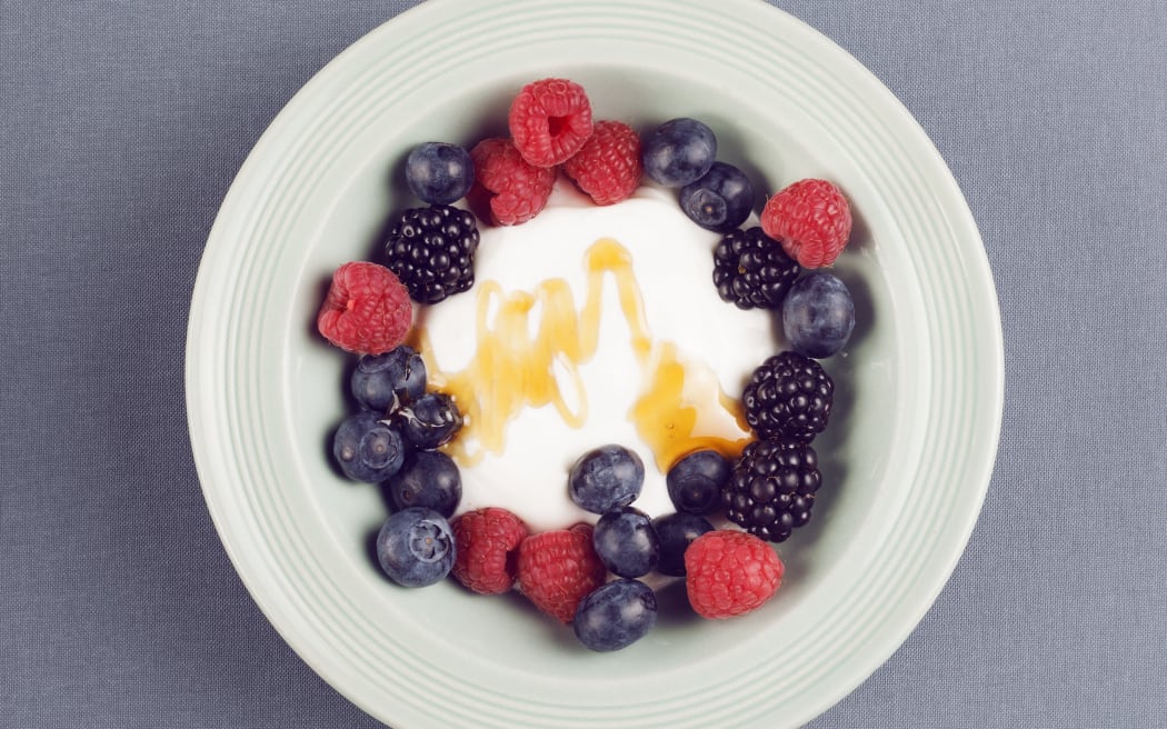 Bowl of fresh berries with yoghurt, studio shot. (Photo by CRISTINA PEDRAZZINI/SCIENCE PHOT / CPD / Science Photo Library via AFP)