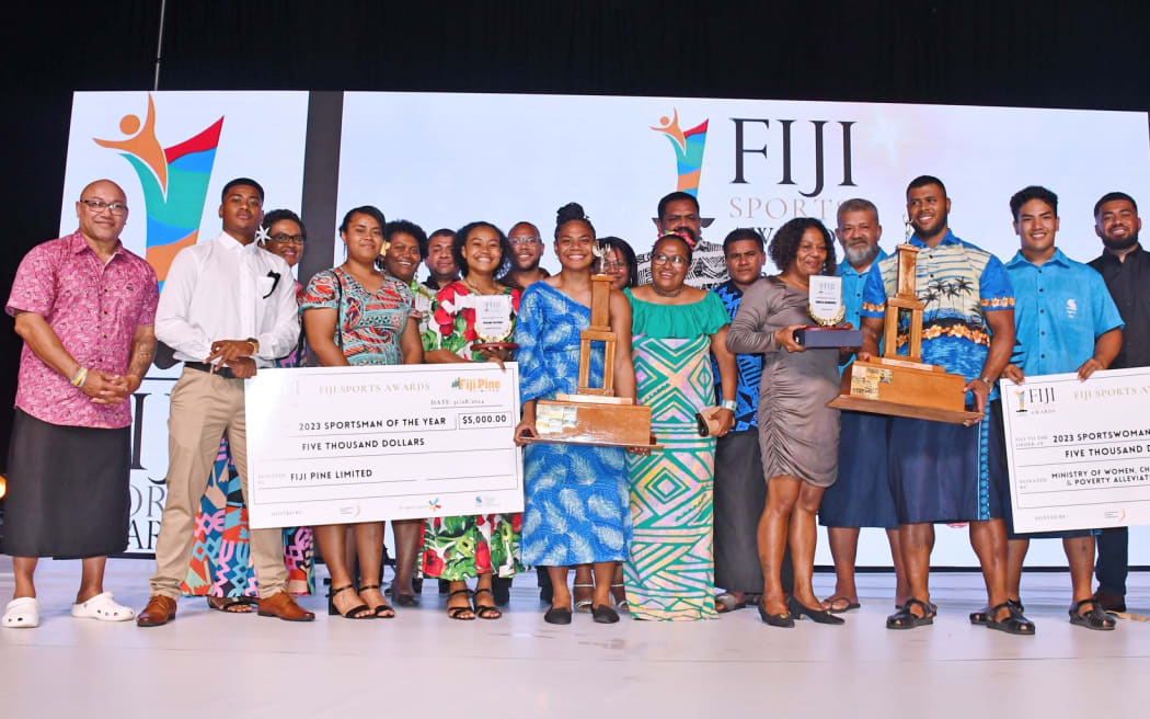 Weightlifting Fiji team with their top athletes Miriama Taletawa, Taniela Rainibogi and President Della Shaw (in green dress middle of the group).