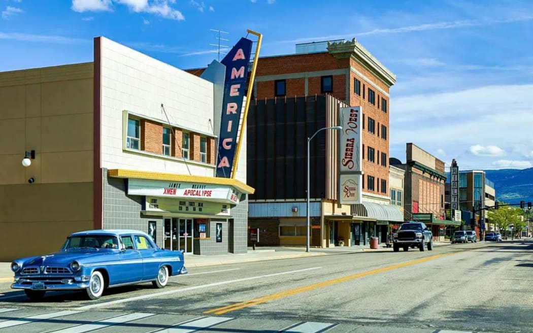 A car parked outside a movie theatre in the main street of Casper Wyoming in the 1950s