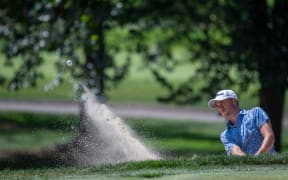 Justin Thomas (USA) hits out of the bunker.