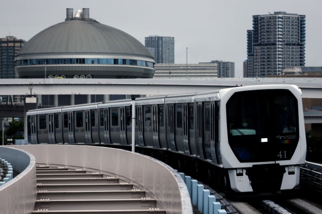 This photo taken on August 2, 2021 shows a train making its way along the Yurikamome line in Tokyo's Koto district. (Photo by David GANNON / AFP)