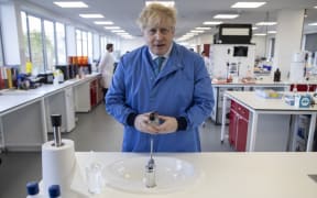 Britain's Prime Minister Boris Johnson gestures during a visit to the Mologic Laboratory in the Bedford technology Park, north of London on March 6, 2020. -