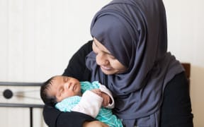 Widow Sanjida Neha and her baby daughter Noor e Omar. The father was mosque victim Omar Faruk.