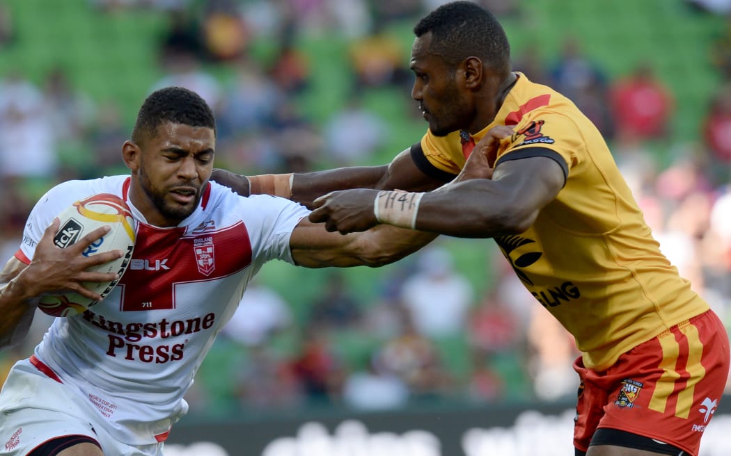 Kato Ottio, (right), tackles of England's Kallum Watkins during the Rugby League World Cup quarter-final in November
