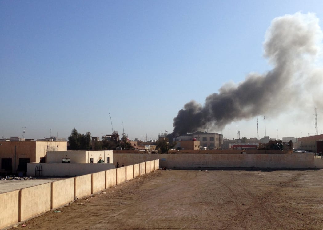 Smoke billows after a mortar explosion in the Hosh district of Ramadi on 11 March 2015.