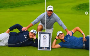 Dan Bradbury (left), Ryan Fox (middle), and Min Woo Lee, pose with the Guinness World Record certificate.