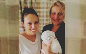 PM Jacinda Ardern with her new baby and her midwife Libby.