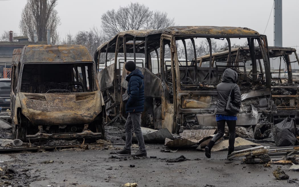 Local residents inspect damaged cars at the site of a Russian attack in Odesa on February 13, 2026, amid the Russian invasion of Ukraine.