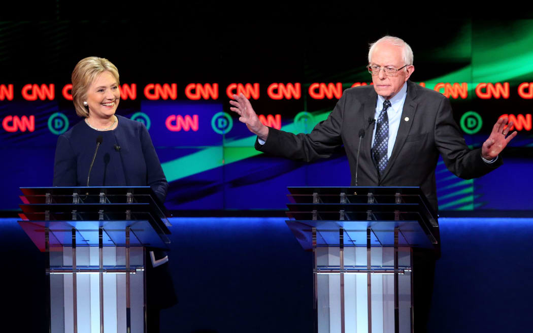 Democratic presidential candidate Senator Bernie Sanders (D-VT) and Democratic presidential candidate Hillary Clinton speak during the CNN Democratic Presidential Primary Debate at the Whiting Auditorium at the Cultural Center Campus on March 6, 2016 in Flint, Michigan.