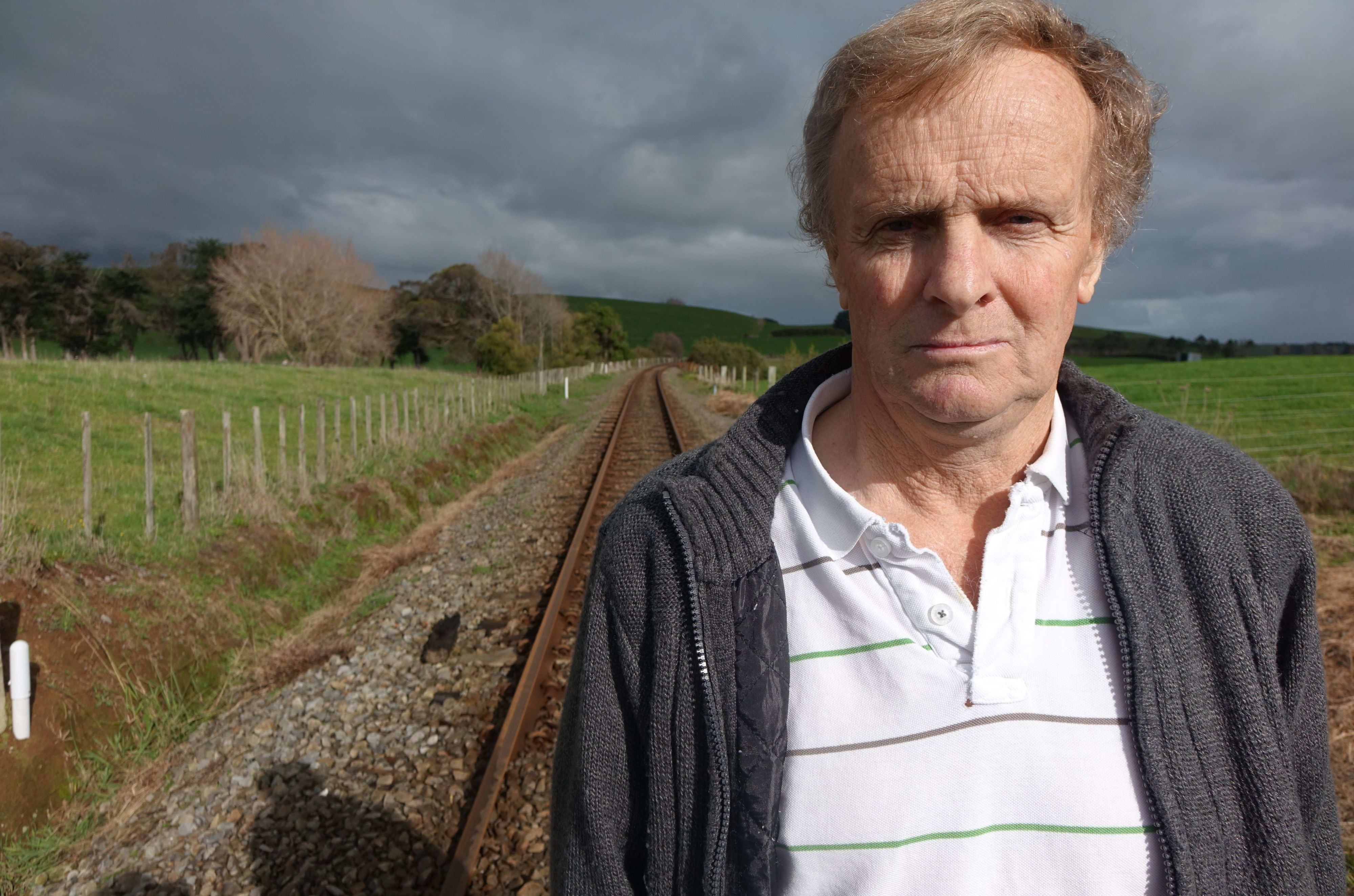 Bill Gribble in front of the level crossing near his land.