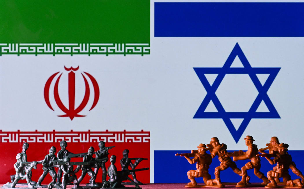 EDMONTON, CANADA - APRIL 15:
Illustrative photo of small figures of soldiers representing two armies in front of the flags of Iran and Israel displayed on a computer screen, on April 15, 2024, in Edmonton, Alberta, Canada. (Photo by Artur Widak/NurPhoto) (Photo by Artur Widak / NurPhoto / NurPhoto via AFP)