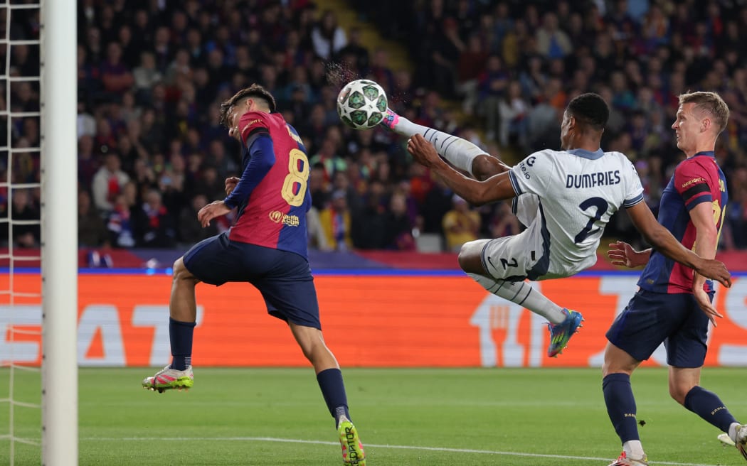 Inter Milan's Denzel Dumfries scores his team's second goal during the UEFA Champions League semifinal first leg match against Barcelona at the Estadi Olimpic Lluis Companys in Barcelona, April 30, 2025.