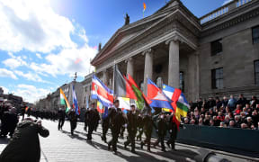 Members of the Irish army march past the General Post Office, the scene of the 1916 Easter Rising