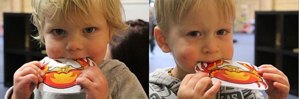 Photos of young children chewing pictures of crabs