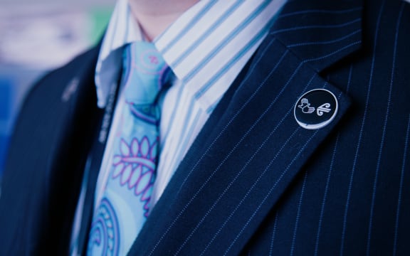 The NZSL Supporter lapel pin indicates the crew member has started training in sign language.