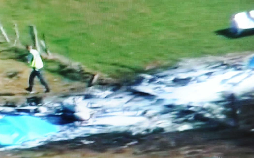 This television frame grab taken from TVNZ television on September 4, 2010 shows the wreckage of a Fletcher FU24 turbine powered skydiving aircraft in a field near Fox Glacier.