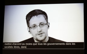 In this file photo taken on July 05, 2017 US intelligence contractor and whistle blower Edward Snowden delivers a speech by video conference during a masterclass at the Maison de la Radio, in Paris.
