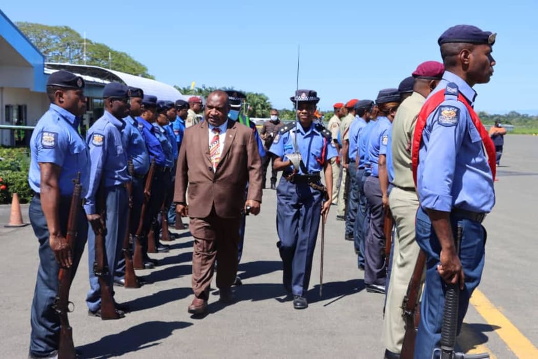 PNG police attend to Prime Minister James Marape as he arrives in Alotau for an official visit to Milne Bay province, 22 August 2020.