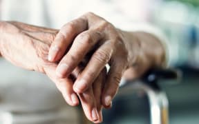 Close up hands of senior elderly woman patient suffering from pakinson's desease symptom. Mental health and elderly care concept