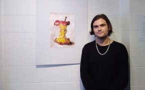 Artist Ben Stewart with some of his art.