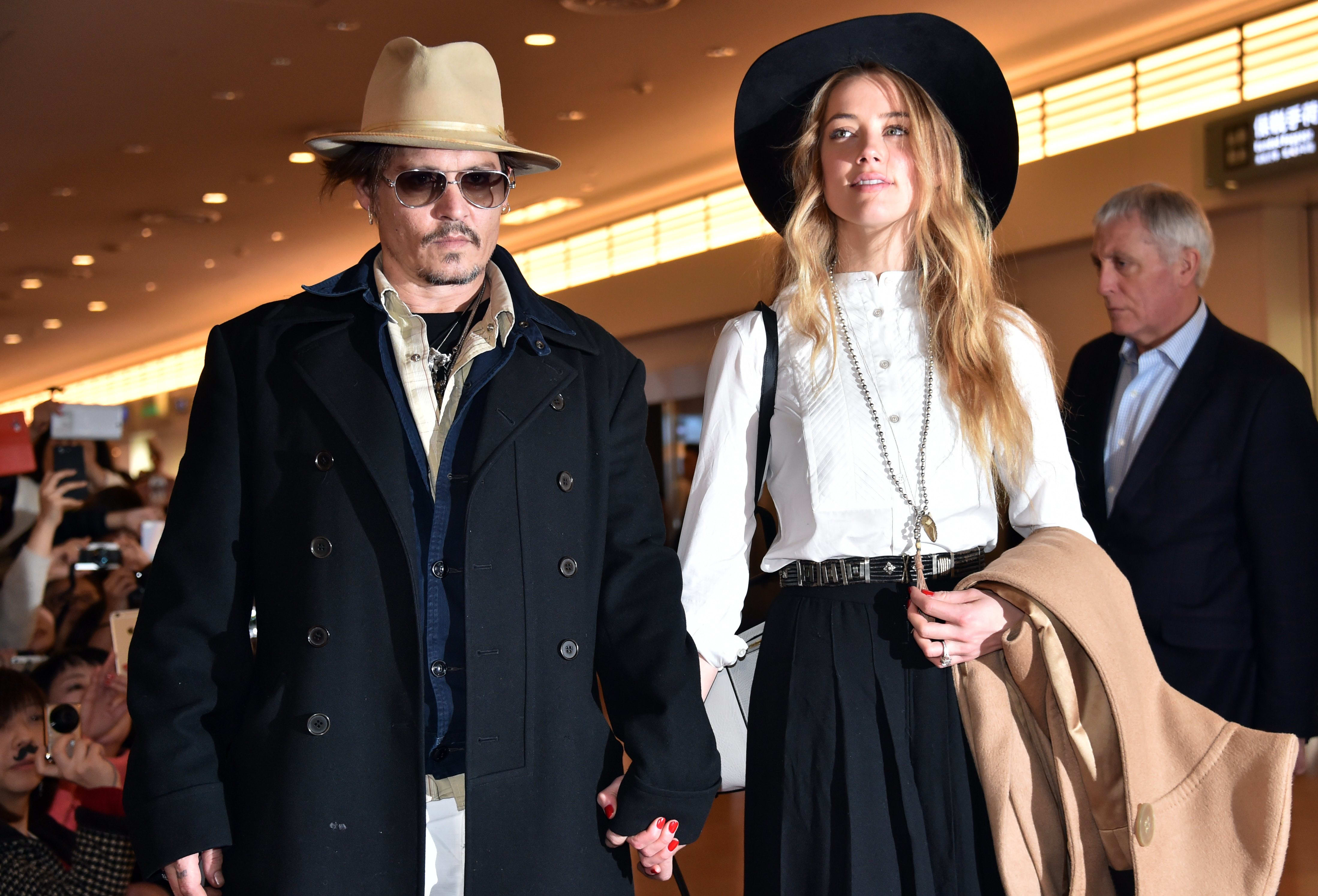 Johnny Depp, accompanied by his then-fiancee Amber Heard, at Tokyo International Airport on 26 January 2015.