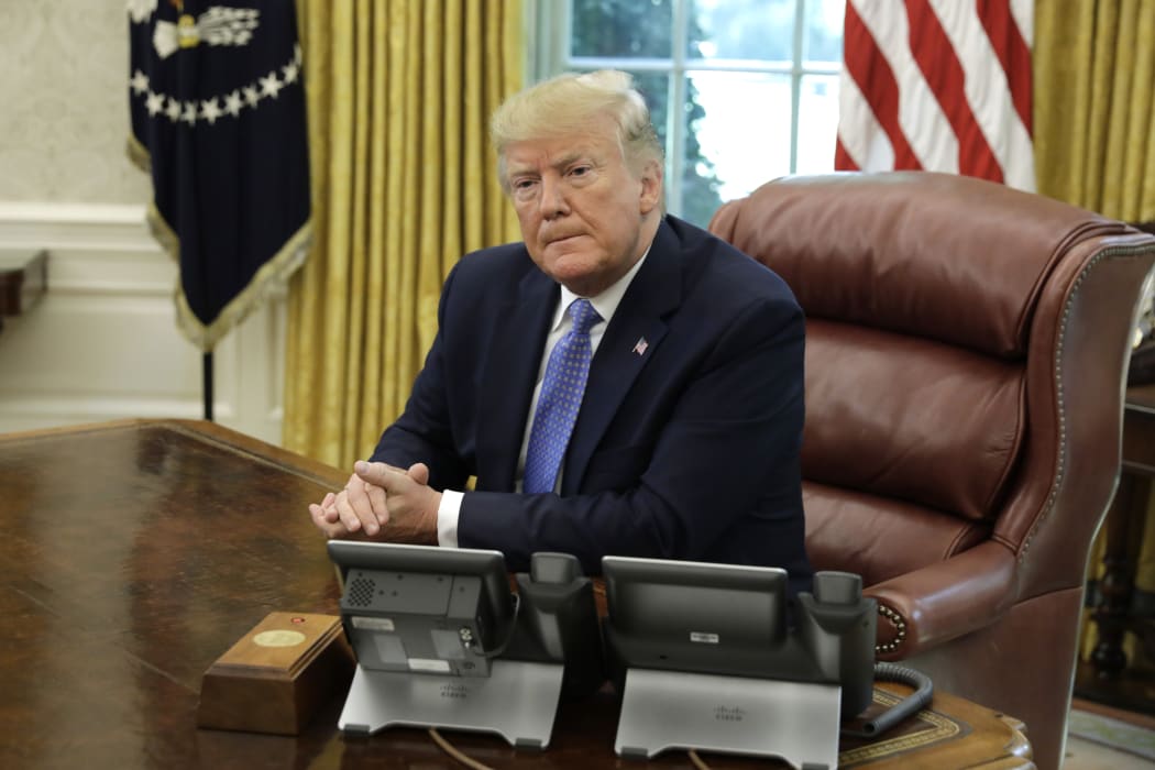US President Donald Trump listens during a meeting on the the opioid epidemic in the Oval Office at the White House in Washington, D.C., on June 25, 2019. | usage worldwide
