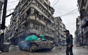 Syrian pro-government forces advance in the Jisr al-Haj neighbourhood during the ongoing military operation to retake remaining rebel-held areas in the northern embattled city of Aleppo on December 14, 2016.